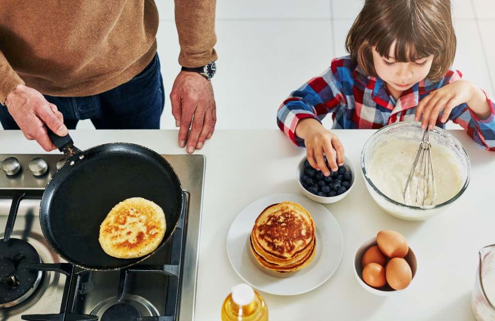 A child helping her father while cooking at The Varsity in Centralia, Washington