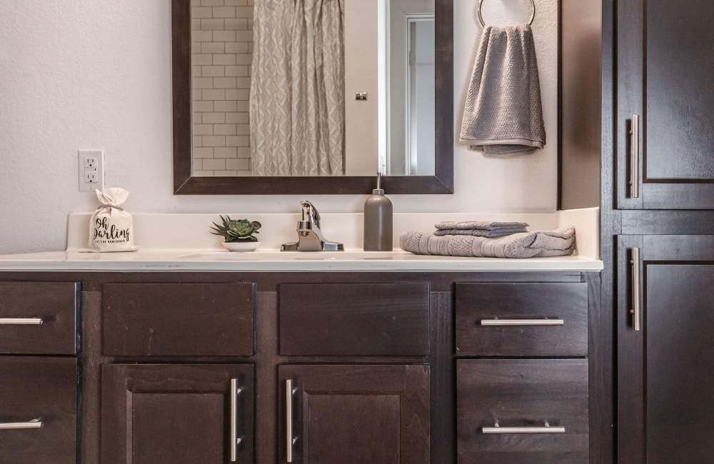 Bathroom with large mirror at Alcove at Alamo Heights in San Antonio, Texas