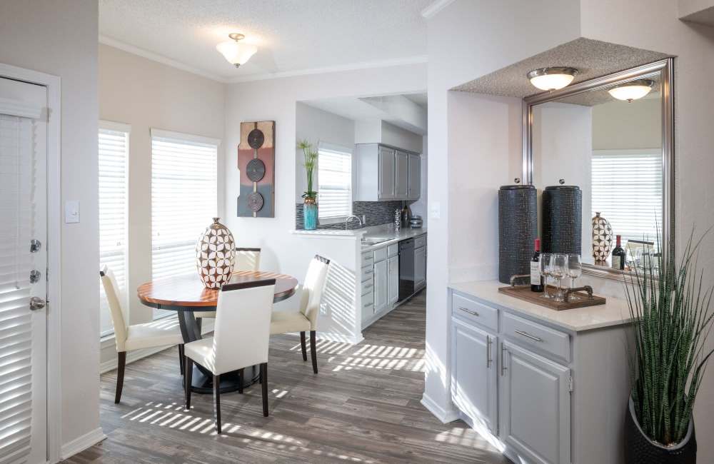 Apartment kitchen with modern appliances and a cozy dining spot beside it at Copper Chase in Arlington, Texas