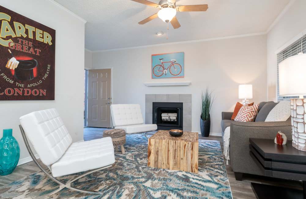Well-designed model apartment living space with fireplace at Copper Chase in Arlington, Texas