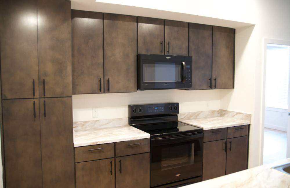 Kitchen with black appliances at Norman Commons in , Texas