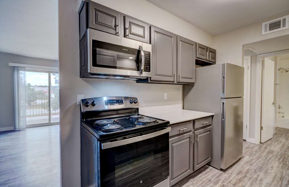 Kitchen with grey color cabinet at Council Crossing in Bethany, Oklahoma
