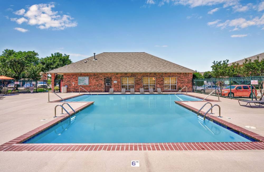 Pool with lounge chair at Oak Place Apartments in Oklahoma City, Oklahoma