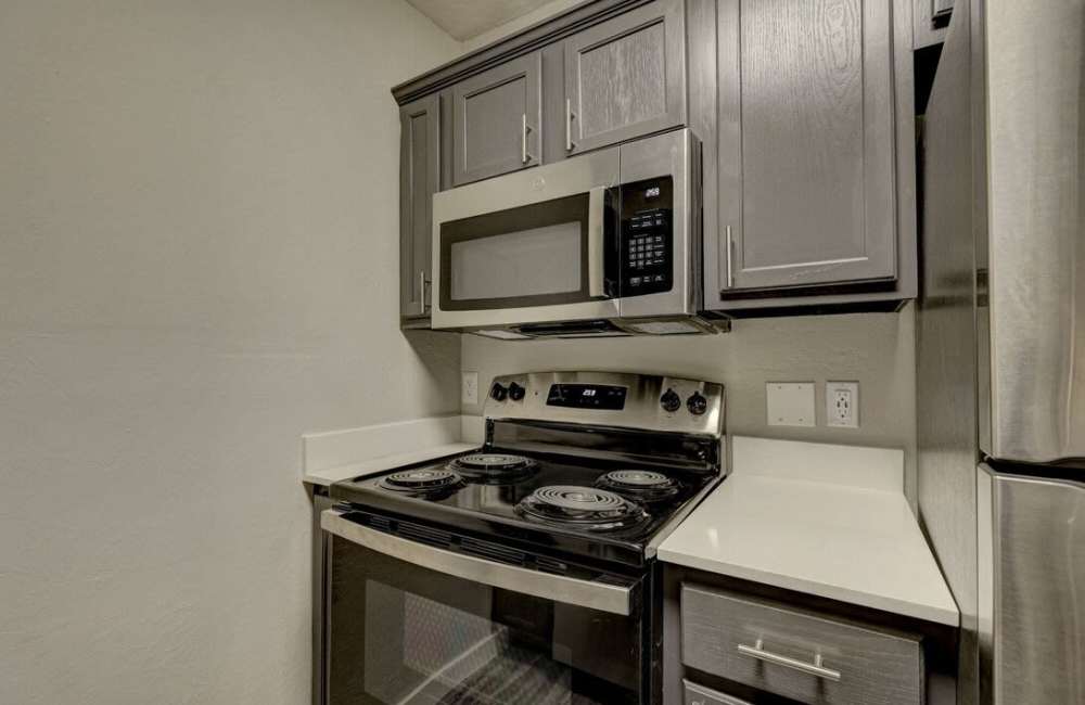 Kitchen with stainless steel appliance at Oak Place Apartments in Oklahoma City, Oklahoma
