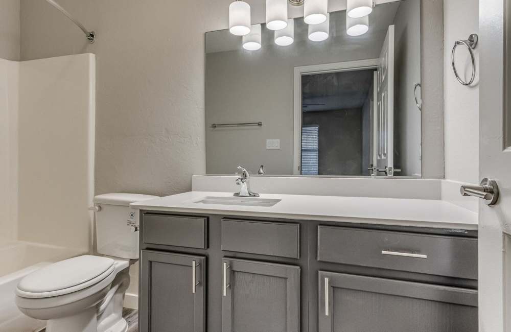 Bathroom with vanity mirror at Oak Place Apartments in Oklahoma City, Oklahoma