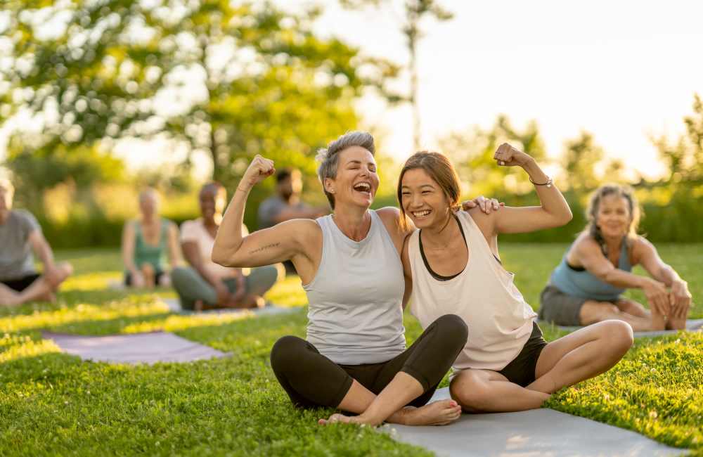Residents practicing yoga joyfully at Mansions at Riverside in Tulsa, Oklahoma