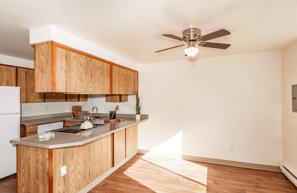 Staged kitchen and living room in Heron Hills Apartment Homes in Gresham, Oregon
