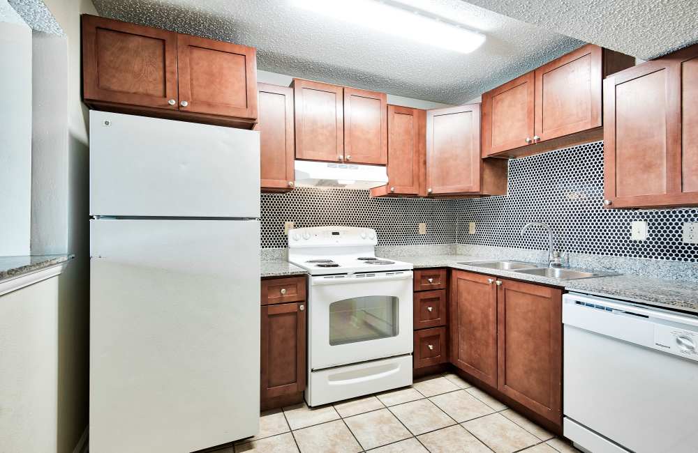 Kitchen with wooden cabinetry at Villas at Emerald Park in Gretna,Louisiana