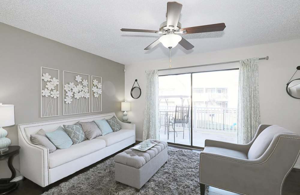 Modern-style living room with access to patio at Derby Park Apartments in Round Rock, Texas