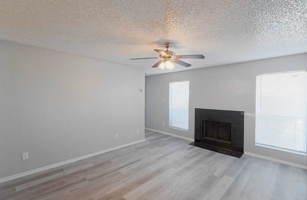 Unfurnished living room with fireplace at Derby Park Apartments in Round Rock, Texas