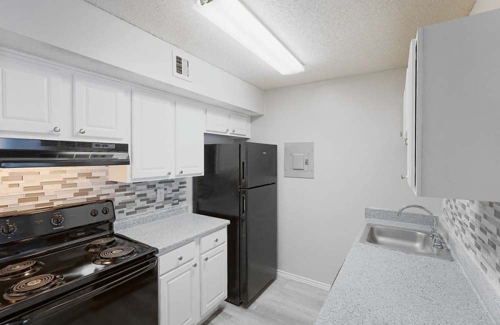 Kitchen with white cabinetry at Derby Park Apartments in Round Rock, Texas