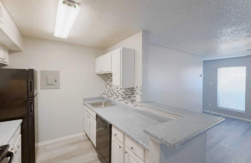 Kitchen with breakfast countertops at Derby Park Apartments in Round Rock, Texas