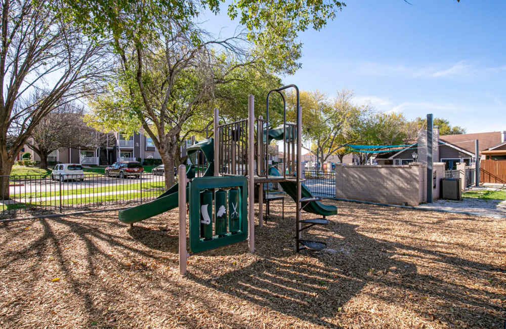 Playground area with children sliders at Derby Park Apartments in Round Rock, Texas 