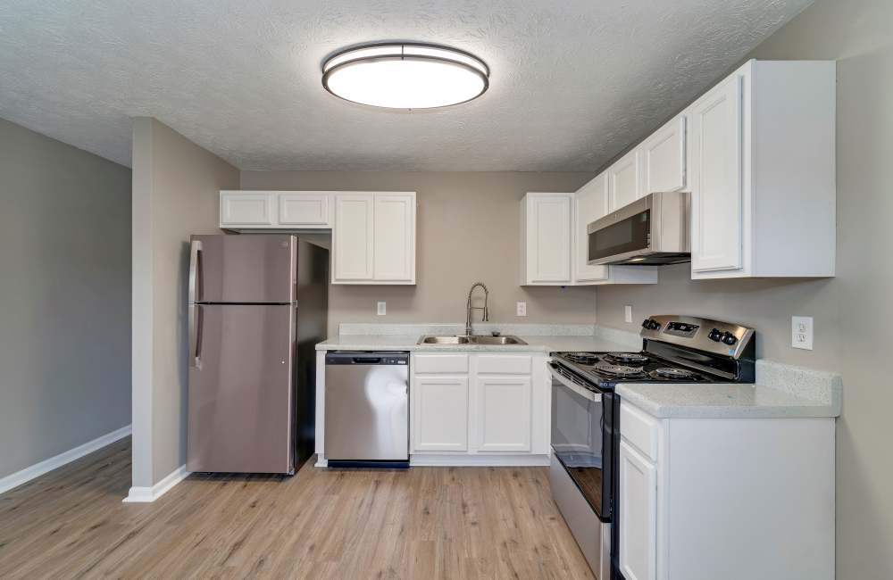 Kitchen with wooden cabinets and stainless-steel appliances at The Avenue in Cartersville, Georgia