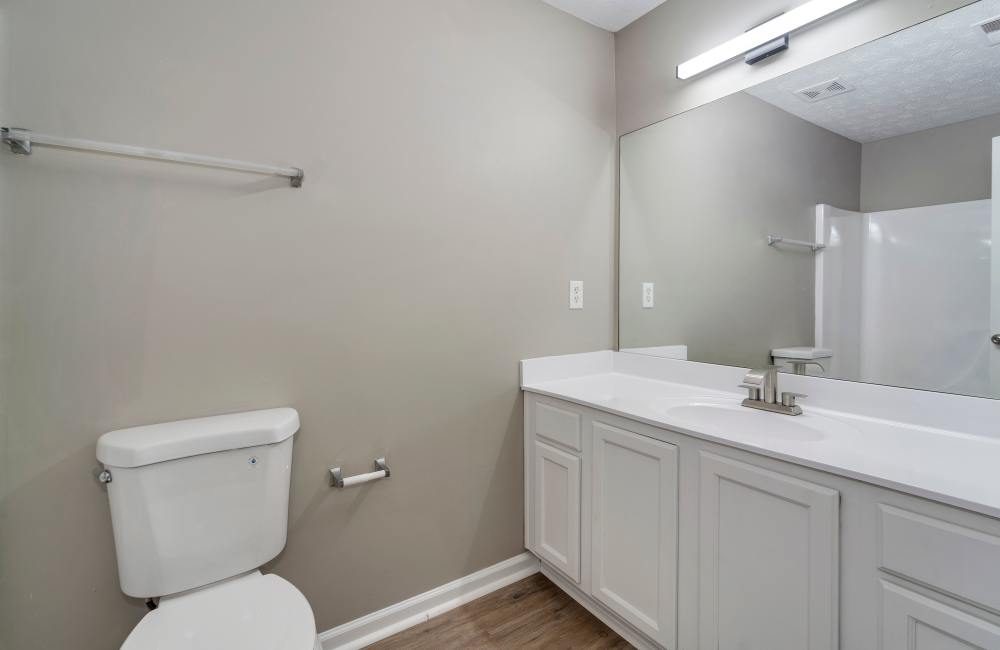 Bathroom with a mirror and a toilet at The Avenue in Cartersville, Georgia