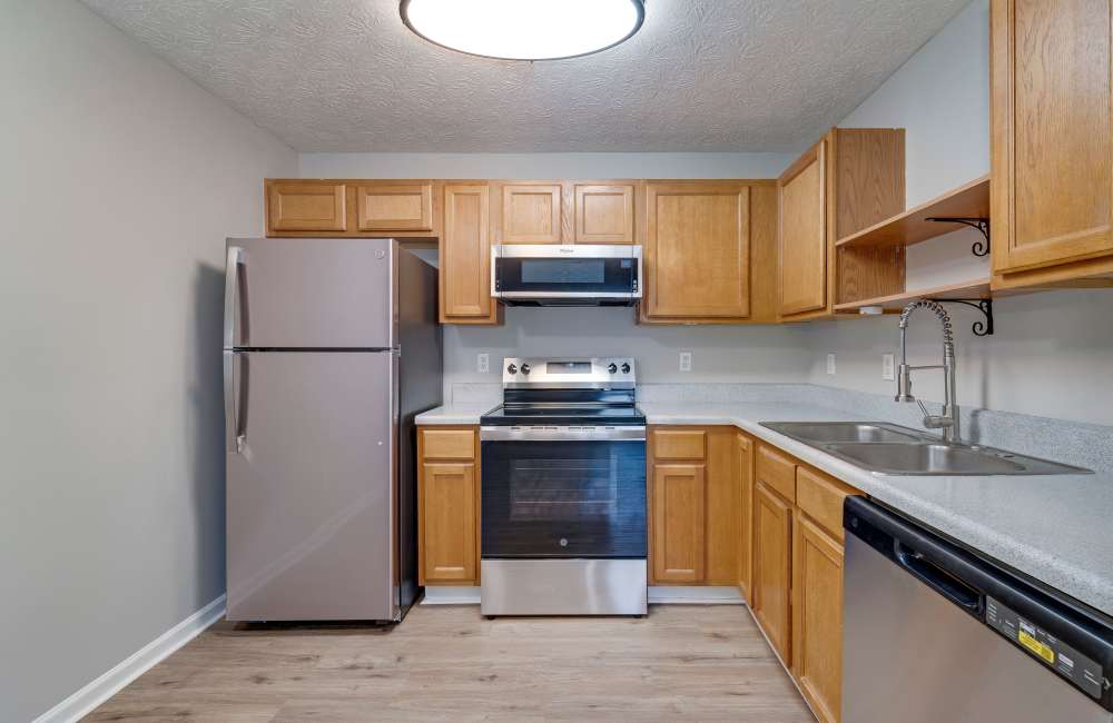 Kitchen with wooden cabinets at The Avenue in Cartersville, Georgia