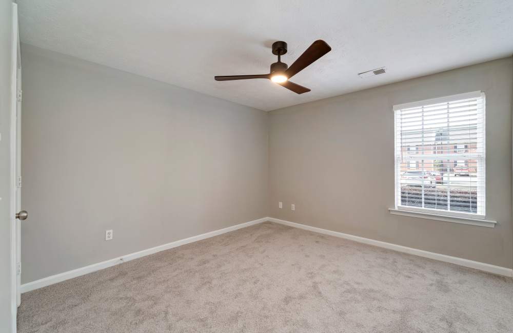 Bedroom with a ceiling fan and a window at The Avenue in Cartersville, Georgia