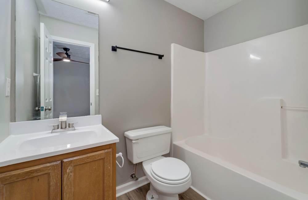 Bathroom with a toilet and a bathtub at The Avenue in Cartersville, Georgia
