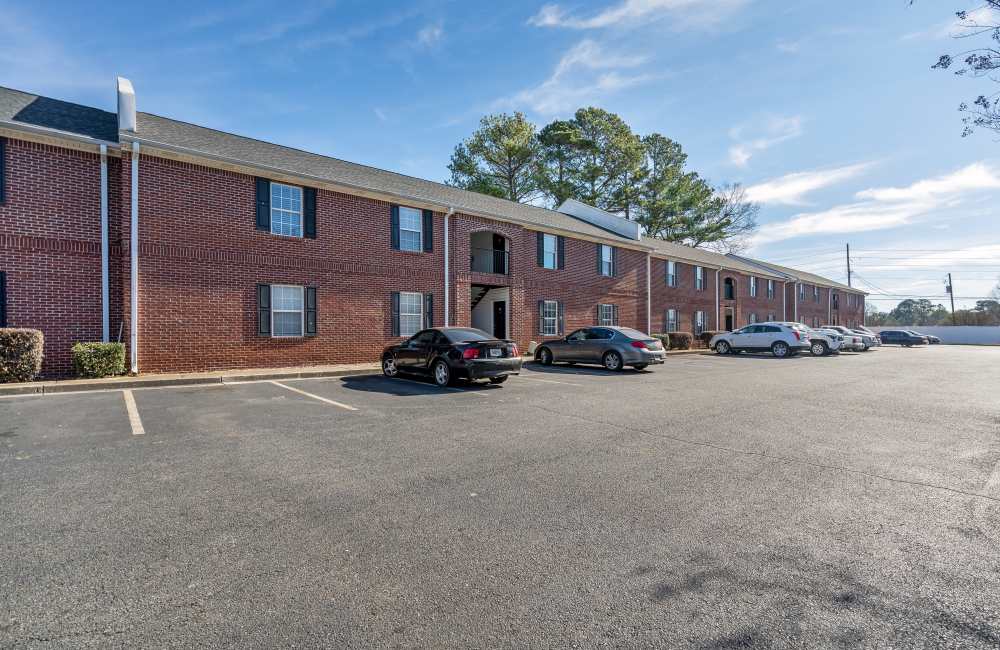 Building exterior with cars parked in front of the building at The Avenue in Cartersville, Georgia