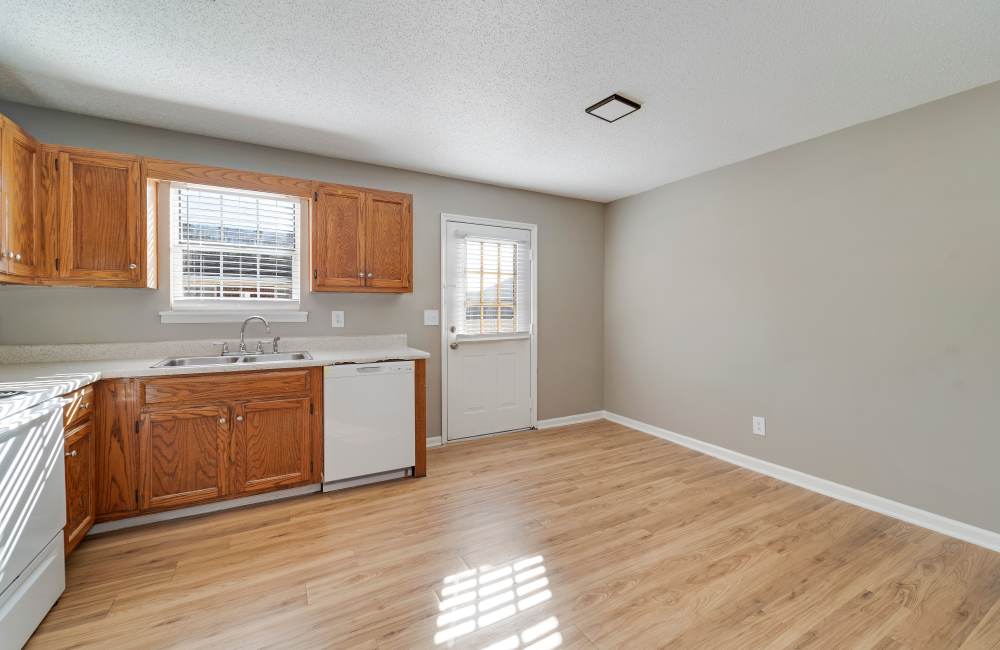 Upgraded kitchen with wooden cabinets and bright natural light at Collins Pointe in Cartersville, Georgia