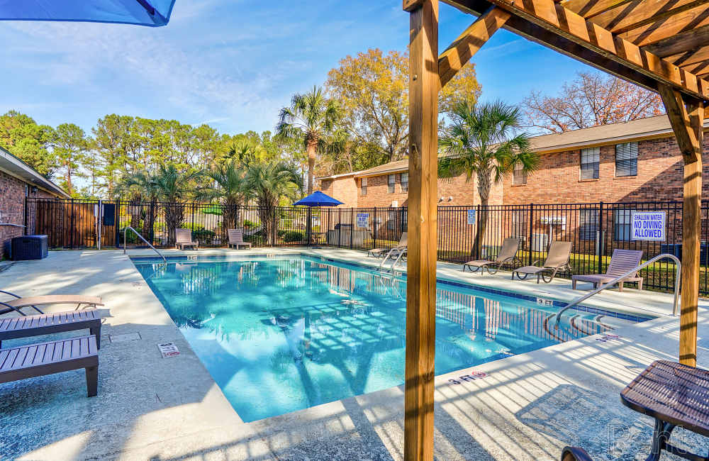 Swimming pool with lounge seating and canopy at Pine Lakes in , South Carolina