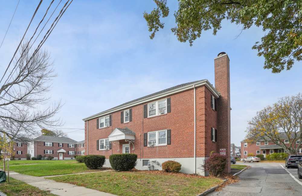Community exterior view with grass lawn at Arlington Gardens in Arlington, Massachusetts