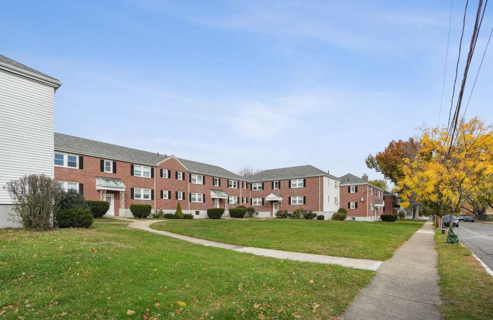 Community exterior view  with sidewalk at Arlington Gardens in Arlington, Massachusetts