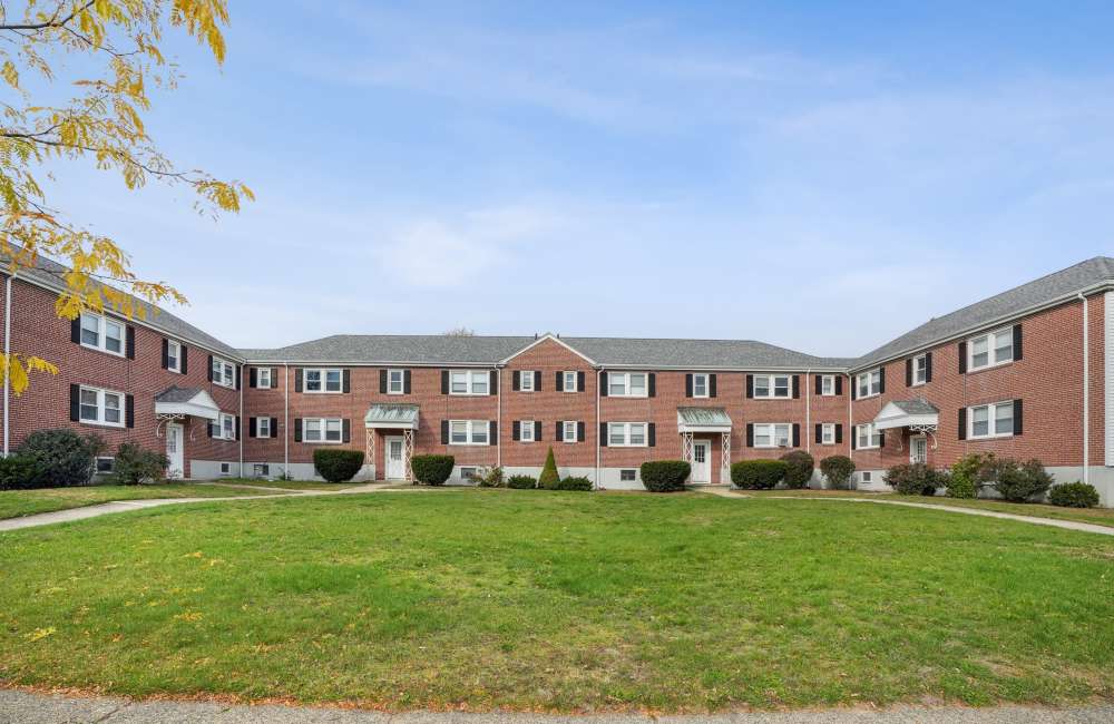 Community exterior view with grassy area   at Arlington Gardens in Arlington, Massachusetts
