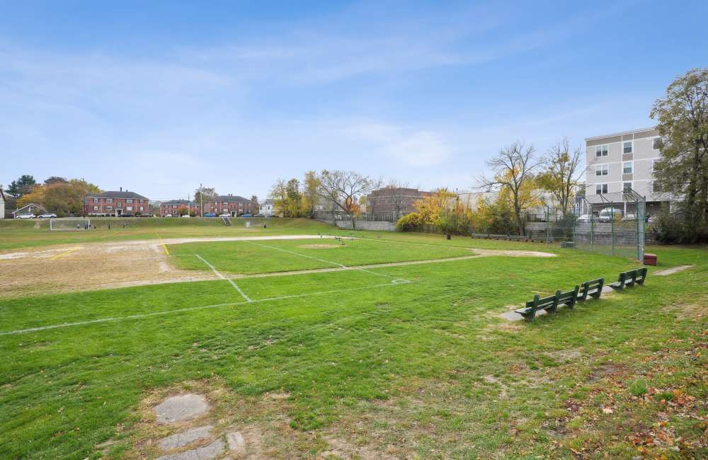 Community playground with bench at Arlington Gardens in Arlington, Massachusetts