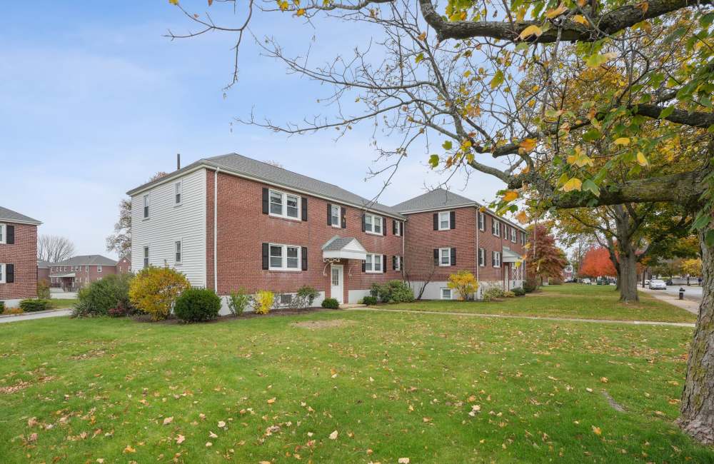 Community exterior view with building entrance at Arlington Gardens in Arlington, Massachusetts