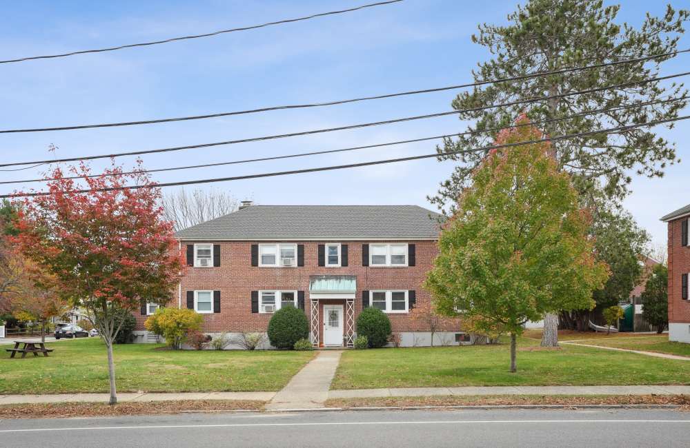 Community exterior view with lots of tree  at Arlington Gardens in Arlington, Massachusetts