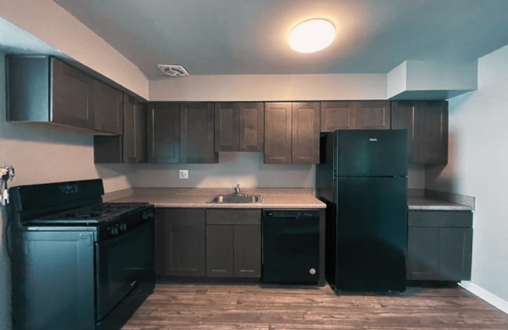 Well-equipped kitchen with wooden cabinets at Williston Townhomes in Baltimore, Maryland