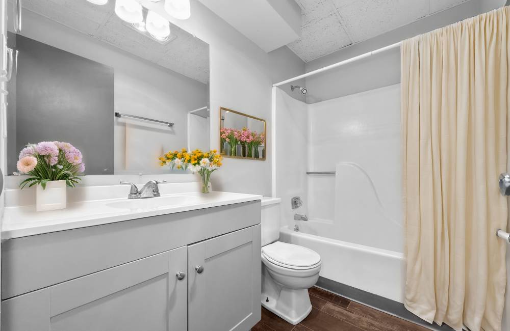 Bathroom with frameless vanity mirror at Eastwood on Grand in West Des Moines, Iowa