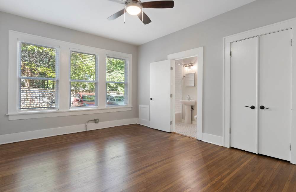 Unfurnished bedroom with windows and attached bathroom at The Alma in Memphis, Tennessee