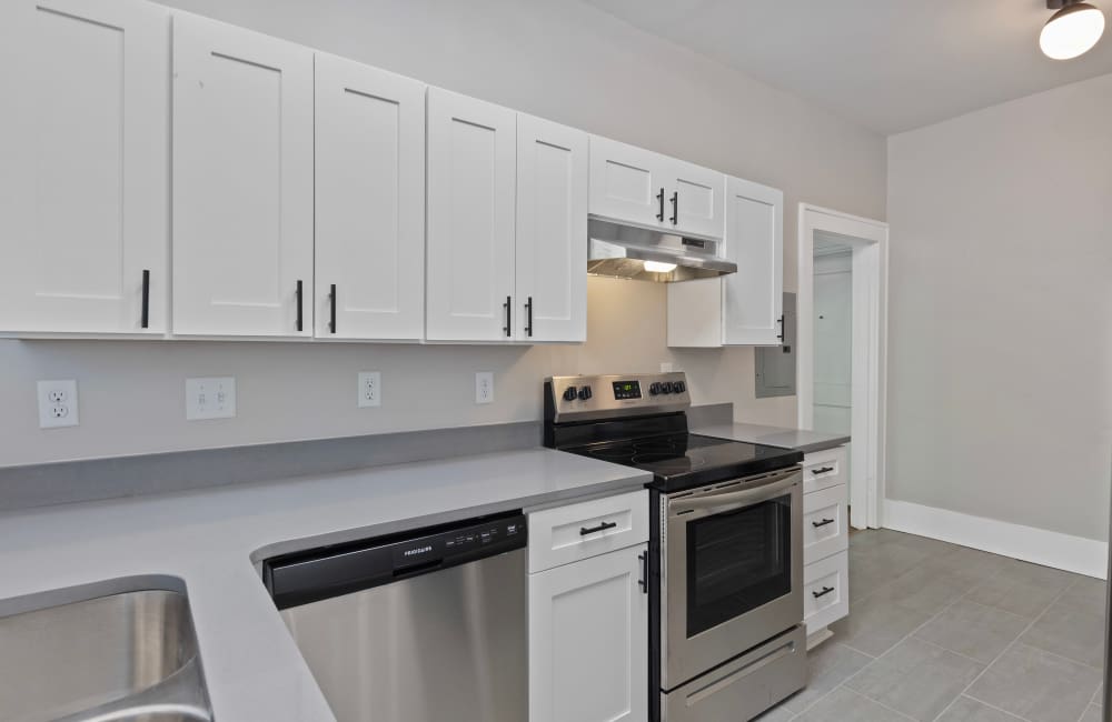Kitchen with steel appliances and tile flooring at The Alma in Memphis, Tennessee