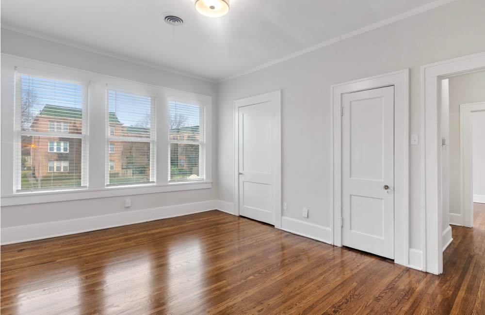 Unfurnished room with wood floor, windows and closed rooms at The Alma in Memphis, Tennessee