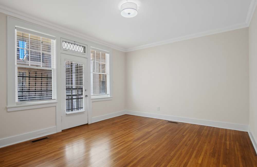 Open layout carpeted living room with plenty of room for a couch, coffee table, and more at The Linden in Memphis, Tennessee