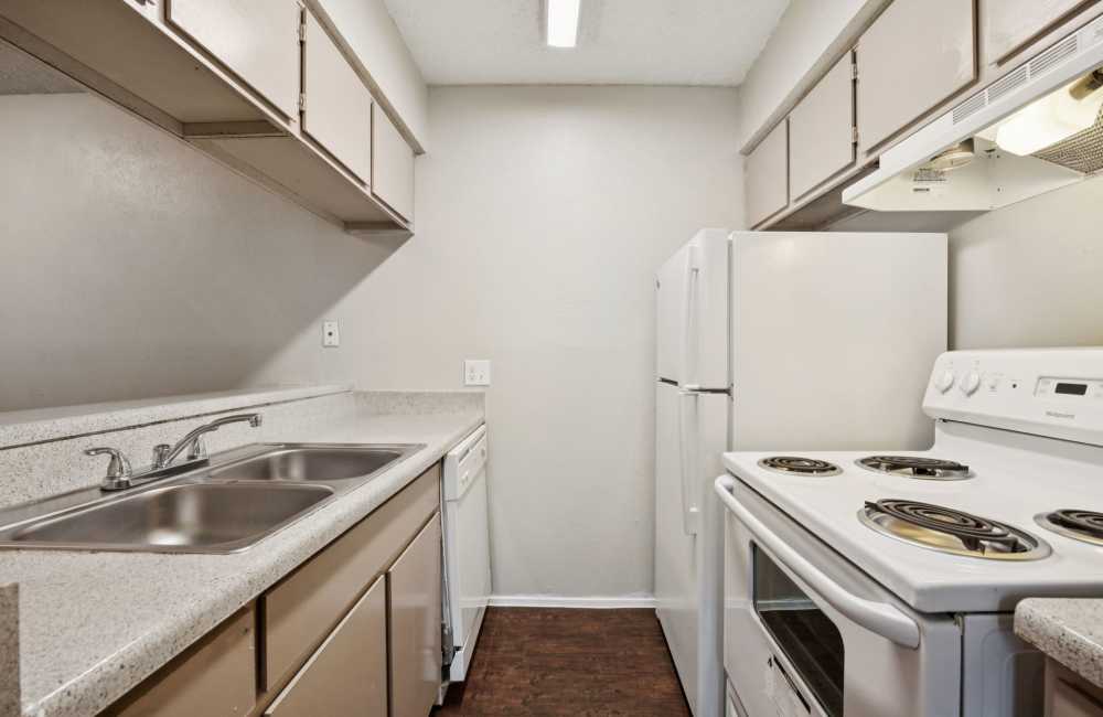Spacious Kitchen with white appliances at Sleepy Hollow in Arlington, Texas