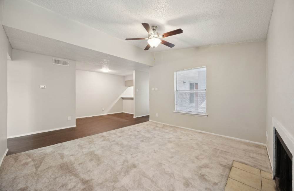View of dining area from living room with fire place and ceiling fan at Sleepy Hollow in Arlington, Texas