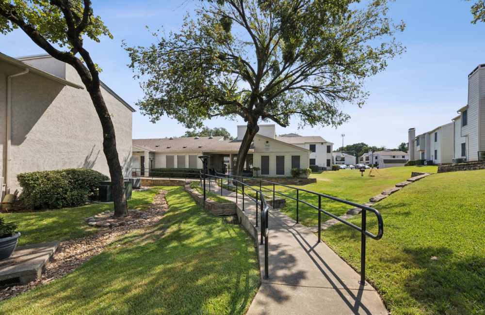 view of the community with green lawn and path ways at Sleepy Hollow in Arlington, Texas