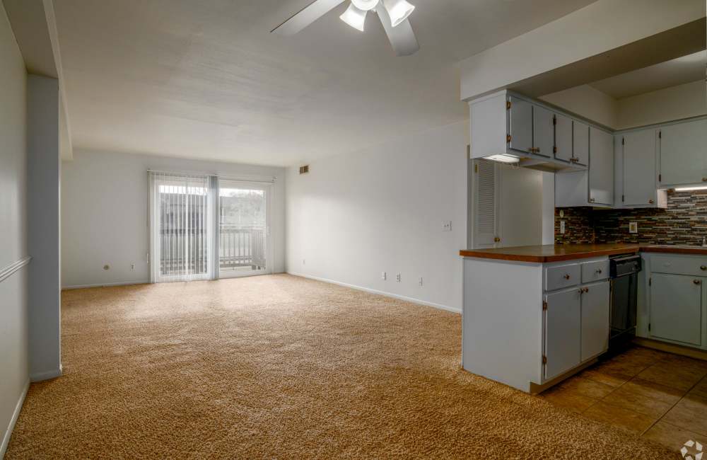 Kitchen and living room in a home at Cambridge Manor Apartments in Lansing, Michigan