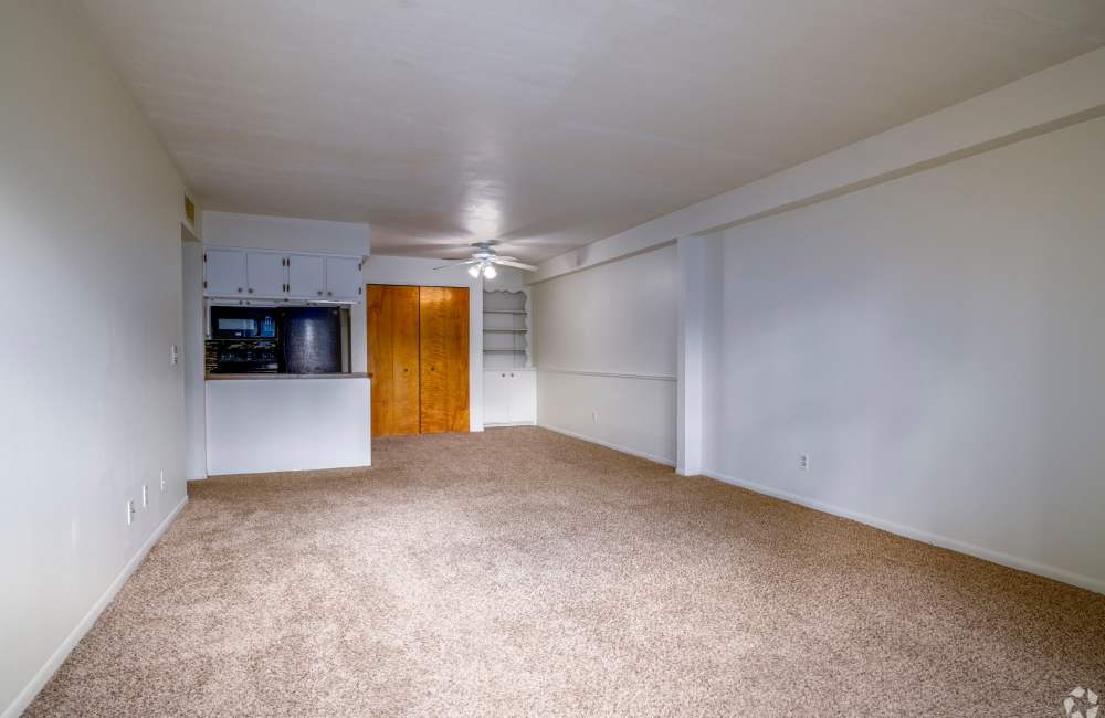 Apartment kitchen and living room at Cambridge Manor Apartments in Lansing, Michigan