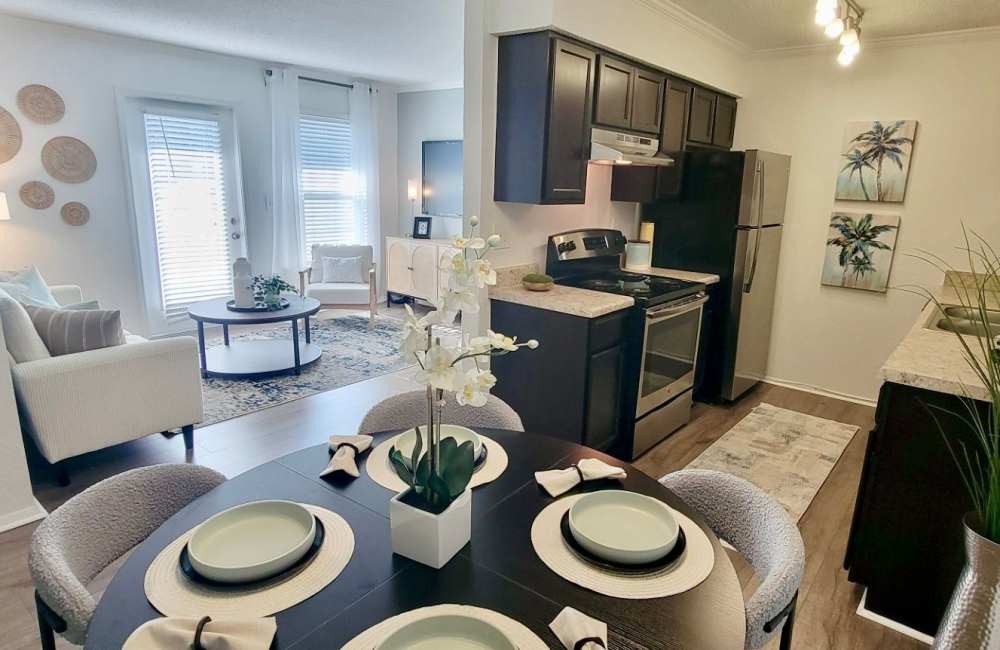 Modern kitchen with wood cabinets and granite countertop at The Abbey At Northlake in Riviera Beach, Florida