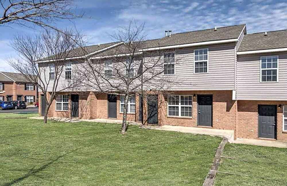 Townhome exteriors and green lawns at Mountain Brook Townhomes in Nashville, Tennessee