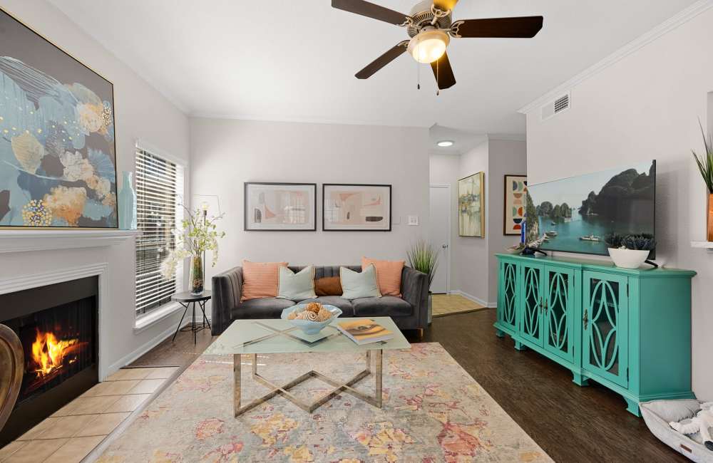Living room with close access to dining area and kitchen at The Reston Apartments in Conroe, Texas