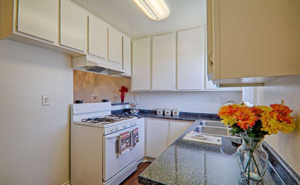 Modern kitchen with all the conveniences in model home at Woodlands West Apartment Homes in Lancaster, CA