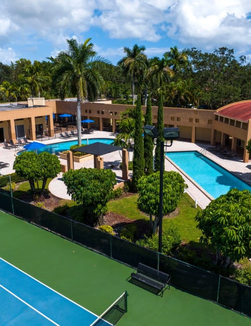 An aerial view of the tennis court, pools and trees at Azalea Village in West Palm Beach, Florida