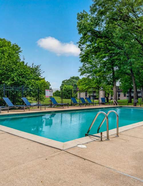 Swimming pool with sun loungers at Tanglewood Apartments in Hammond, Indiana