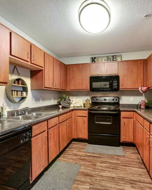 Apartment kitchen with light wooden cabinets at Altitude at Baton Rouge in Baton Rouge, Louisiana