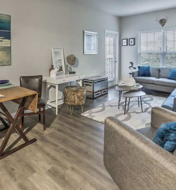 A furnished apartment living room and dining room at Retreat at the Park in Burlington, North Carolina